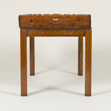 An early 19th century rectangular oak tray with open fretwork gallery, on a later stand.