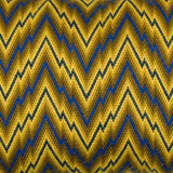 A blue and yellow flame-stitch cushion.
