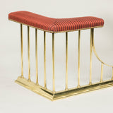 An early 20th century brass club fender, the seat recovered in striped horsehair fabric.