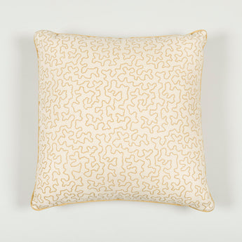 A 16” cushion in Squiggle Silhouette caramel finished with contrasted piping.