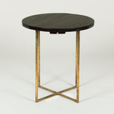 A low round table, the ebonised oak-veneered top with two small slides & simple tubular brass underframe.