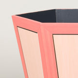 A hexagonal waste paper bin with hand painted faux panel decoration. Paint chart colour No. 5.