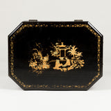 A small Chinese lacquer box decorated in gilt with Chinoiserie scenes, 19th century, on later ball feet.