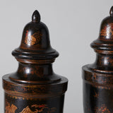 A pair of 19th century turned wooden urns and covers with black red and gilt japanned Chinoiserie decoration.