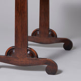 Simple rectangular early 19th century ash wood writing table, the end supports with elegant scrolled feet.