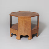 A low octagonal two-tier oak veneered table, early to mid 20th century.