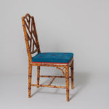A pair of faux bamboo decorated side chairs with arched lattice backs, probably mid-20th century.