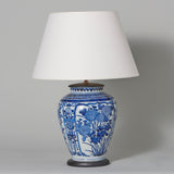 A blue and white Japanese Arita period vase decorated with floral panels, 17th century, wired as a lamp.