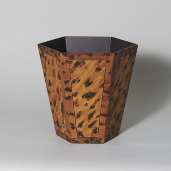 A hexagonal waste paper bin with hand painted faux panel decoration. Tortoiseshell.