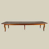 An exceptionally long 19th century French fruit wood farmhouse table with a plank top and lovely colour.
