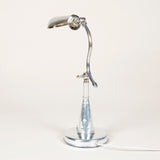 A small chrome articulated desk lamp with a rounded trough shade. French, early 20th century.