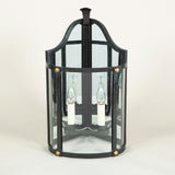A pair of wrought iron corner wall lanterns in a black painted finish with gilt details. £3,400.00 each