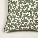 A hand-stitched needlepoint of Colefax and Fowler squiggle design, made up as a cushion.