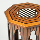 A small octagonal Syrian table with an inset chess board top and Moorish arches enclosing a lower tier.