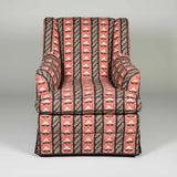 A traditionally upholstered armchair covered in the Sibyl Colefax & John Fowler Strawberry Leaf design.