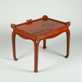A red and gilt chinoiserie decorated tray on a stand, early 20th century European.