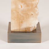 A block of rock crystal mounted on a brass base, wired as a lamp; modern, £950.00 + vat.