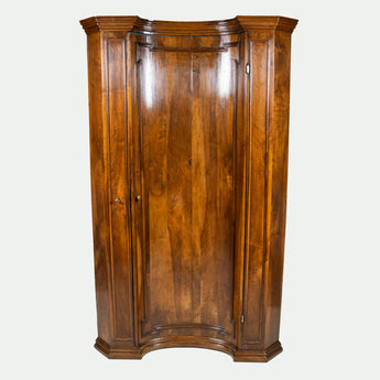 An 18th century walnut floor standing corner cupboard with a single concave door.