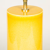 A pair of tall cylinder-shaped pottery lamps with a deep yellow glaze.
