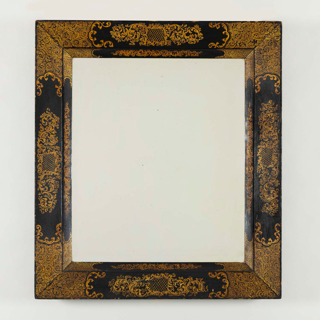 A rectangular 19th century mirror with black and gilt wedge shaped