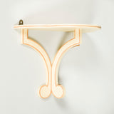 A SIMPLE PAINTED WOODEN WALL BRACKET WITH ADDED LINE DETAIL