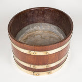 An oval brass-bound coopered mahogany wine cooler or planter. Probably late 19th or early 20th century.