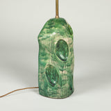 A green studio pottery vase with large dimples, wired as a lamp.