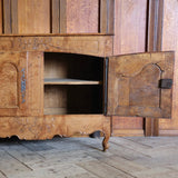 A GOOD QUALITY 18TH CENTURY FRENCH BURR ASH BUFFET OF ELEGANT PROPORTIONS, THE DOORS WITH SERPENTIME SHAPED PANELS AND CARVED BASKET OF FLOWERS MOTIFS TO THE TOP AND APRON.
