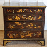 A LATE 19TH CENTURY CONTINENTAL FOUR DRAWER JAPANNED COMMODE WITH CHINOISERIE DECORATION, BRACKET FEET AND DROP HANDLES.