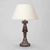 AN ELABORATELY CARVED LAMP BASE WITH A PAINTED BRONZE FINISH, PROBABLY LATE 19TH CENTURY, REWIRED.