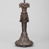 AN ELABORATELY CARVED LAMP BASE WITH A PAINTED BRONZE FINISH, PROBABLY LATE 19TH CENTURY, REWIRED.