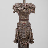 AN ELABORATELY CARVED LAMP BASE WITH A PAINTED BRONZE FINISH, PROBABLY LATE 19TH CENTURY, REWIRED.