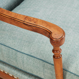 A COTSWOLD STYLE PALE OAK WING ARMCHAIR WITH A SERPENTINE BACK AND TURNED-OUT ARMRESTS. CIRCA 1930.