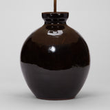 A LARGE BULBOUS DARK BROWN GLAZED JAPANESE VASE WIRED AS A LAMP. MID-20TH CENTURY.