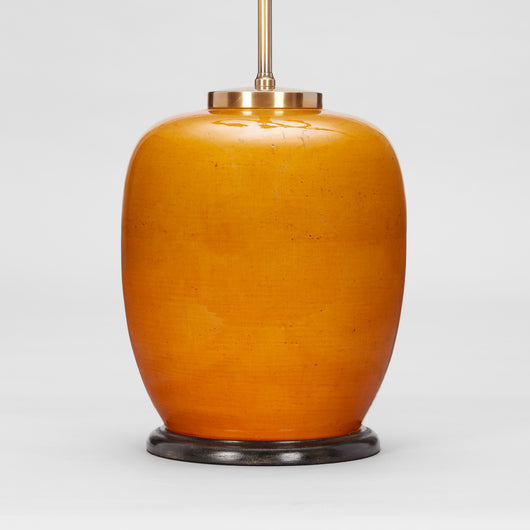 AN EARLY 20TH CENTURY CHINESE VASE IN A DEEP YELLOW GLAZE WIRED AS A LAMP.