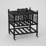 AN EBONISED BOBBIN-TURNED CANTERBURY, ENGLISH LATE 19TH CENTURY.