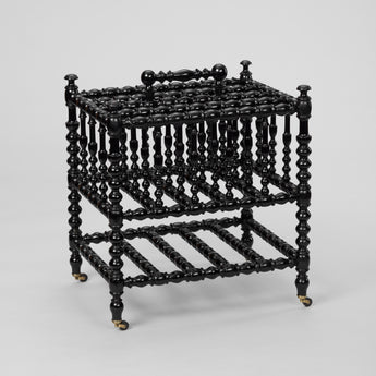 AN EBONISED BOBBIN-TURNED CANTERBURY, LATE 19TH C. ENGLISH.