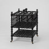 AN EBONISED BOBBIN-TURNED CANTERBURY, ENGLISH LATE 19TH CENTURY.