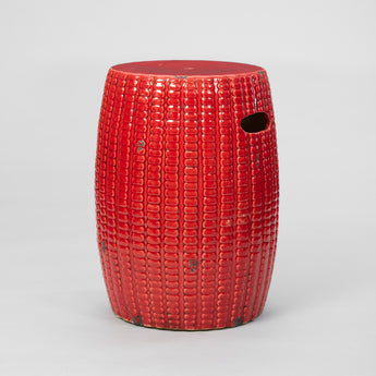 A PAIR OF LATE 20TH CENTURY CERAMIC GARDEN SEATS IN A CHINESE RED GLAZE.