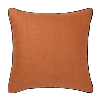 A  SQUARE CUSHION MADE UP IN A RUST COLOURED LINEN WITH CONTRAST OTTOMAN PIPING.