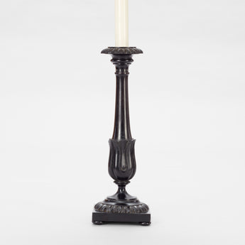 A PAIR OF ANGLO-INDIAN HARDWOOD CANDLESTICKS WITH GADROONING TO THE TOP AND BASE AND A STYLISED TULIP CUP TO THE BASE OF THE TAPERING STEM. WIRED A LAMPS.