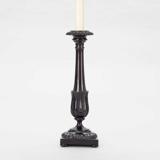 A PAIR OF ANGLO-INDIAN HARDWOOD CANDLESTICKS WITH GADROONING TO THE TOP AND BASE AND A STYLISED TULIP CUP TO THE BASE OF THE TAPERING STEM. WIRED A LAMPS.