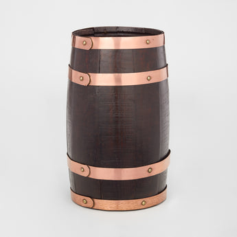 AN EARLY 20TH CENTURY COOPERED DARK OAK BARREL WITH COPPER BANDING.