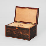 A RECTANGULAR COROMANDEL VENEERED BOX WITH A DIVIDED INTERIOR UNDER A HINGED LID. EARLY 19TH CENTURY.