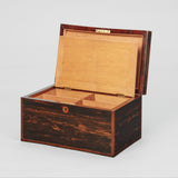 A RECTANGULAR COROMANDEL VENEERED BOX WITH A DIVIDED INTERIOR UNDER A HINGED LID. EARLY 19TH CENTURY.