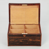 A RECTANGULAR COROMANDEL VENEERED BOX WITH A DIVIDED INTERIOR UNDER A HINGED LID. EARLY 19TH CENTURY.