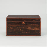 A RECTANGULAR COROMANDEL VENEERED BOX WITH A DIVIDED INTERIOR UNDER A HINGED LID. EARLY 19TH CENTURY.