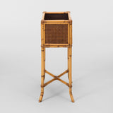 A MID-20TH C. RECTANGULAR BAMBOO AND RATTAN PLANT STAND.