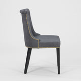 A PAIR OF EARLY TO MID-20TH CENTURY SIDE CHAIRS WITH A SCROLL BACK AND EBONISED LEGS, REUPHOLSTERED IN A BLUE GRAY LEATHER.