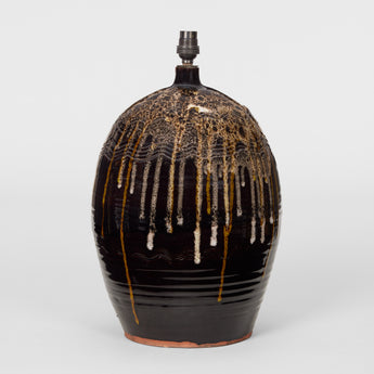 A LARGE VASE LAMP IN A DARK BROWN GLAZE WITH DRIP DECORATION TO THE UPPER SECTION, LATE 20TH CENTURY.